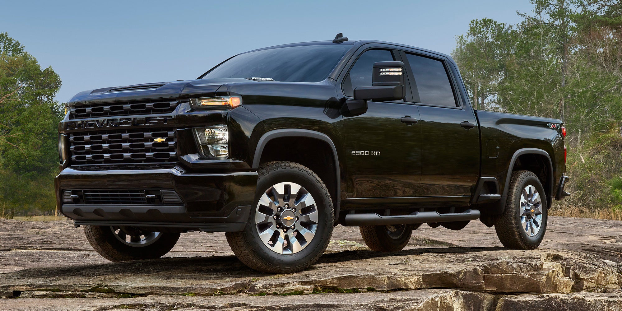 2025 GMC Canyon driving on a dirt road.